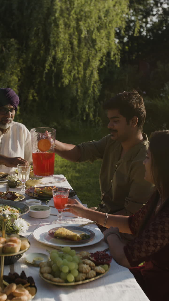 People Enjoying an Outdoor Meal in a Sunny Garden