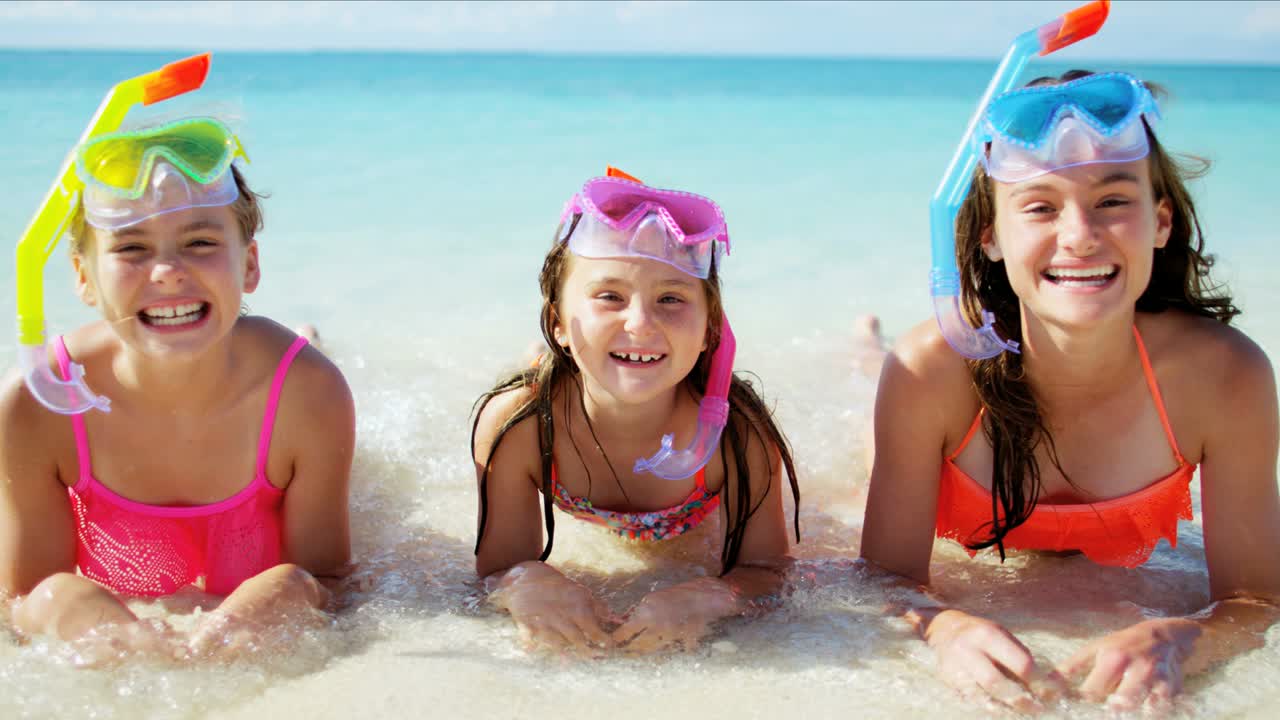 Portrait of Caucasian girls snorkeling on beach vacation