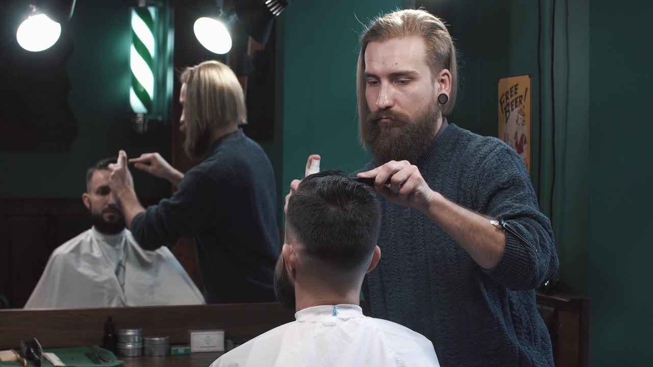 Barber cutting a man's hair in a barbershop