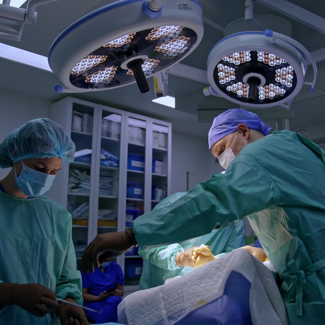 Surgeons perform operation on the foot. Female nurse passes the tools to the doctors