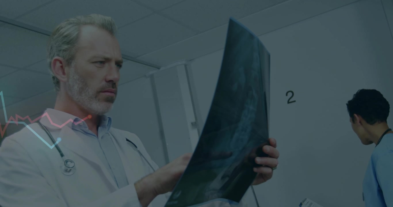 Doctor studying X-ray film in exam room 2 causing pulsing ECG overlay while nurse writing clipboard
