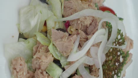 close-up of a fresh tuna salad with greens and onions