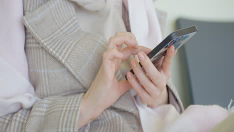 woman using smartphone while sitting