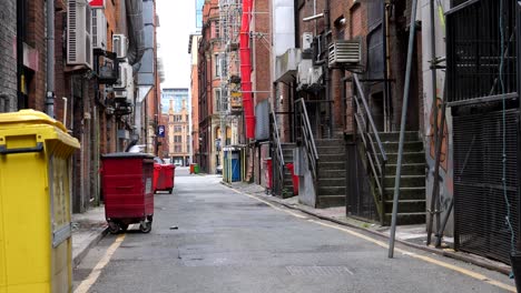 garbage bins in side street in manchester downtown