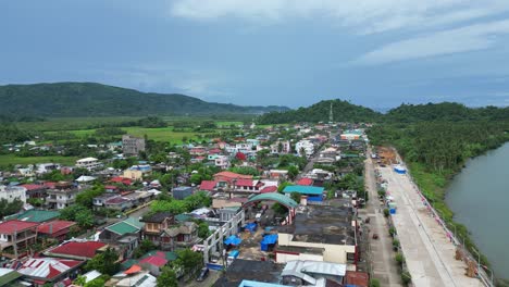 establishing, idyllic drone shot of riverside, local community town in bato, catanduanes