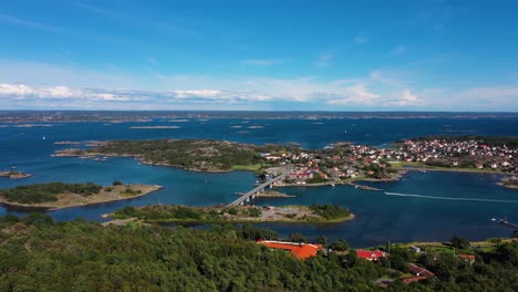 donso island from above with boat cruising in the calm blue sea in sweden. - aerial