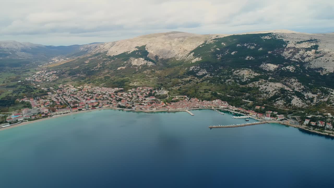Aerial view from the coastline of Baska, Croatia. Amazing mountain landscape in the background. Cloudy day