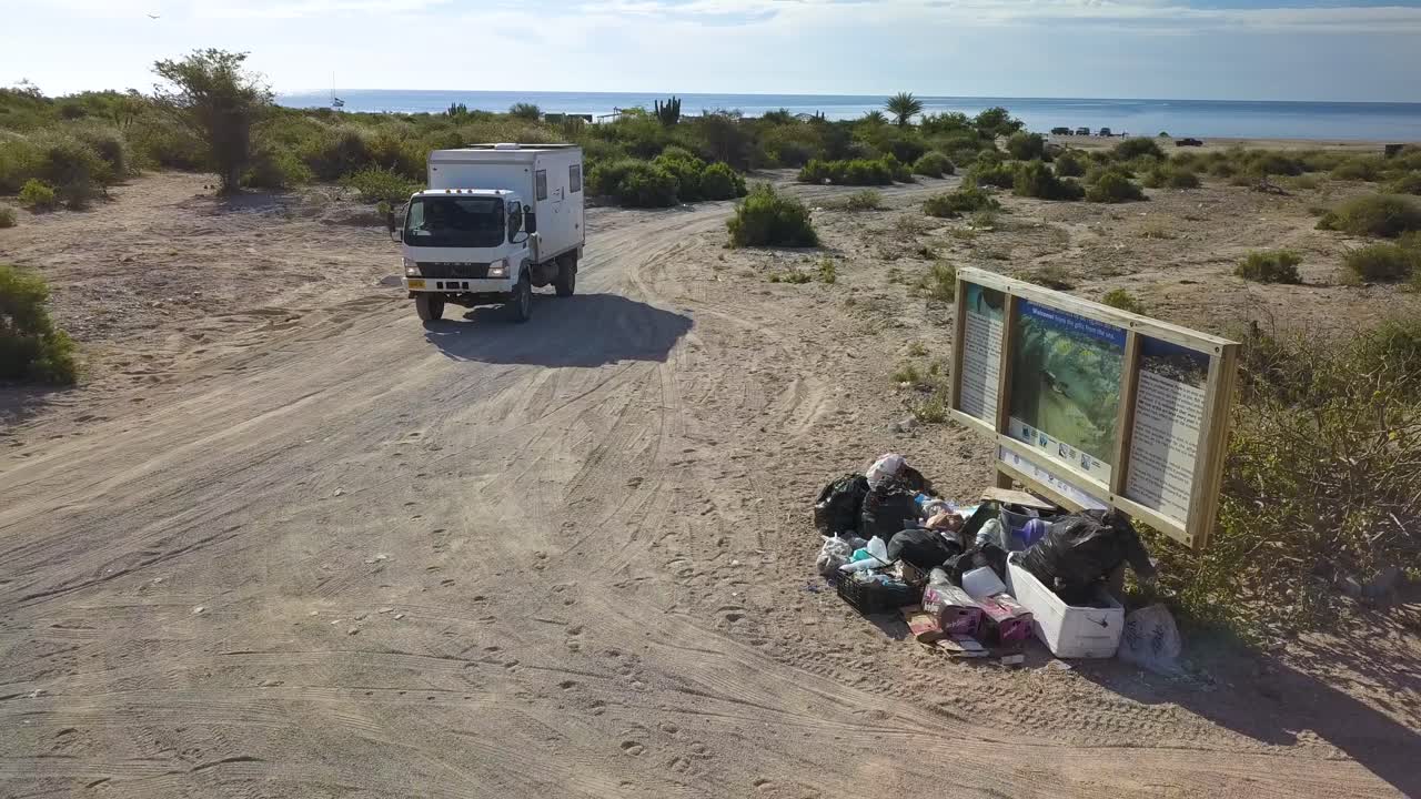 Environmental Cleanup Truck Cleaning Beaches in Baja, Mexico - Aerial Drone Tracking View
