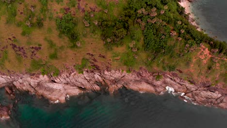 Orbit-drone-shot-of-a-ridge-on-top-of-a-peninsula-located-in-Laem-Phromthep-Cape-in-Phuket-province-in-Thailand