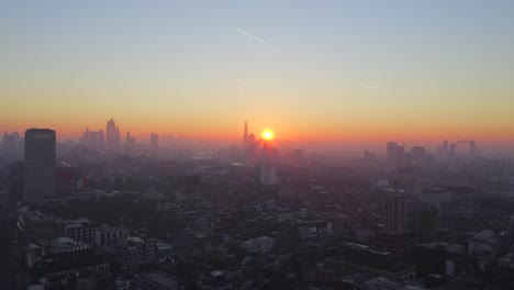 video shows beautiful sunrise in london where the sun shines through the buildings and the city is in golden color