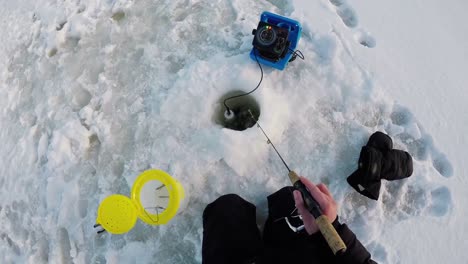 fisherman fishing in snow