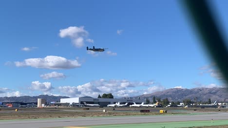 b25 bomber flying low over city