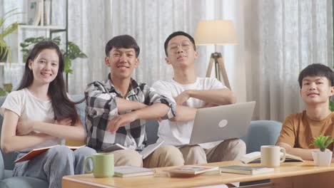 asian teen group studying at home, doing project, smiling and showing arms crossed gesture