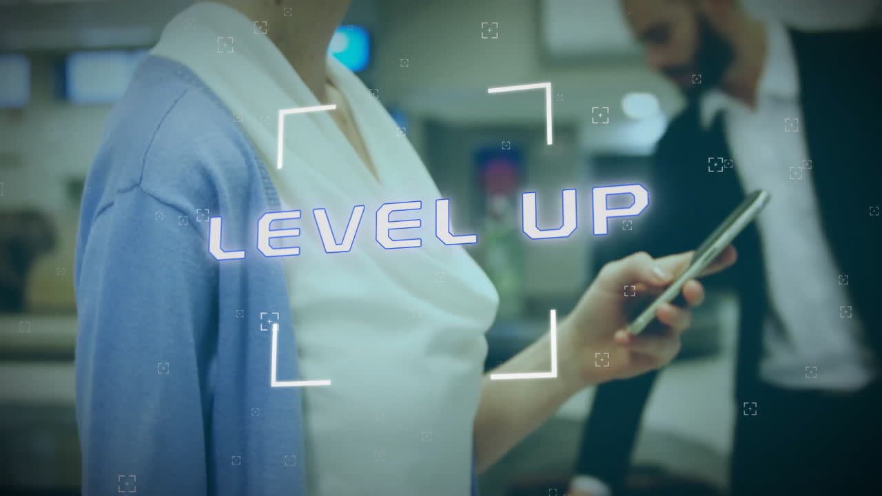 Animation of level up text over caucasian businesswoman using smartphone