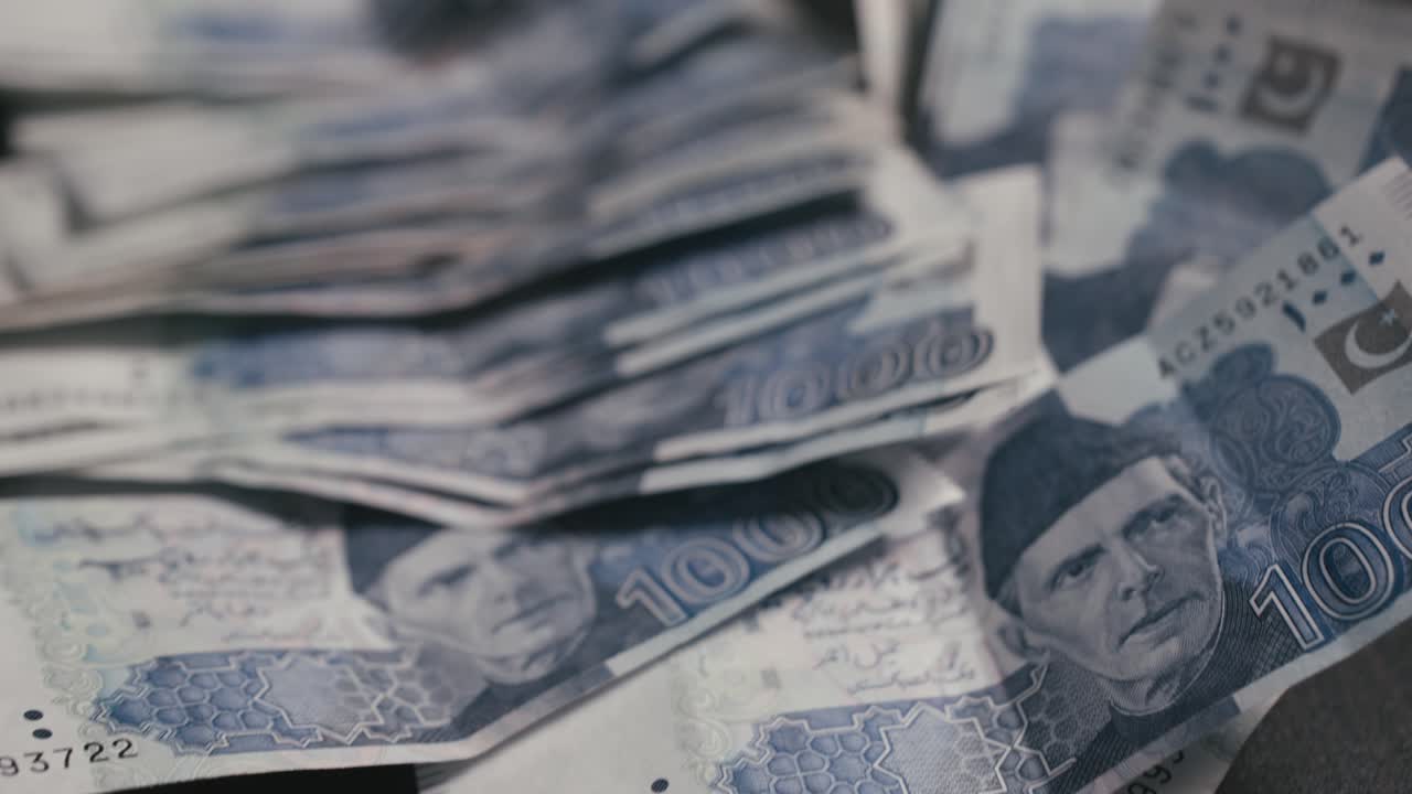 close up dolly shot of 1000 Pakistani currency notes