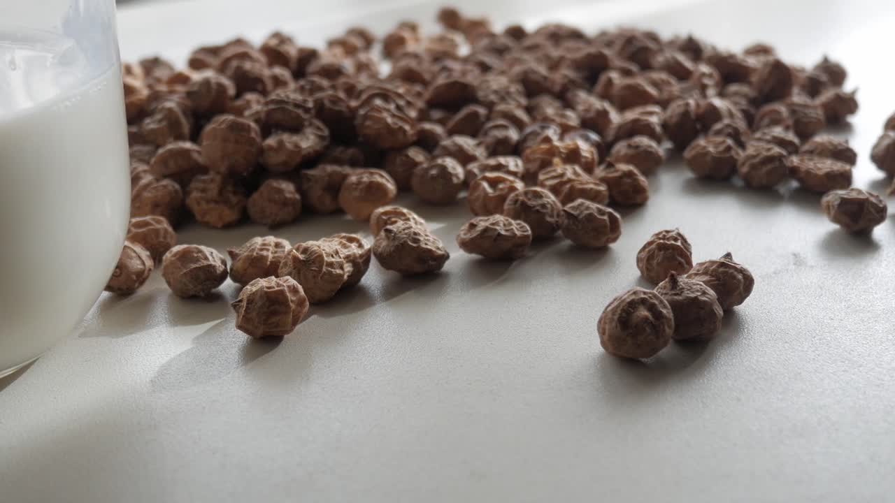 Raw tiger nuts on white background, used for sweet summer drink horchata chufa