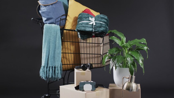 Video of shopping trolley with shopping with copy space over grey background