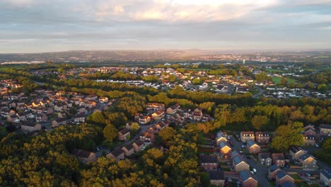 establishing aerial shot of solar powered suburban houses at sunrise in uk