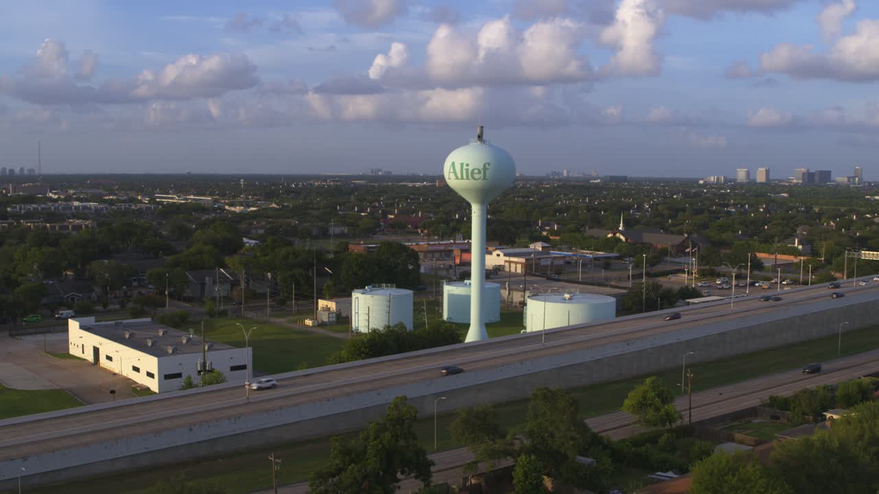 Establishing Drone Shot of Alief Area in Houston Featuring Water Tank and Tollway