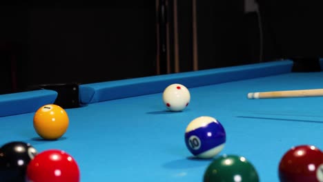 Playing-a-game-of-billiards-hitting-the-orange-ball-in-and-almost-the-cue-ball