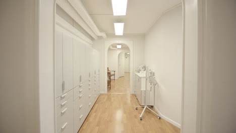 patient pov walking down medical centre corridor into bright dentist's office