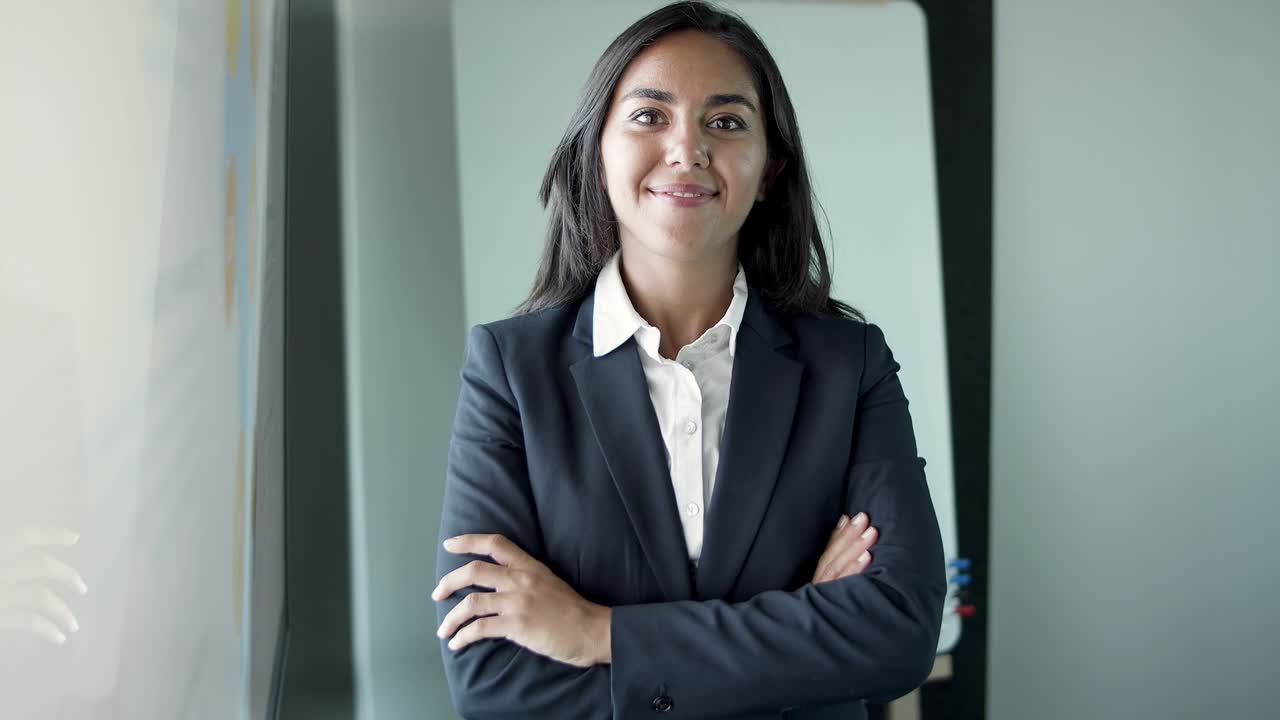 Portrait of Latin pretty young businesswoman standing in office