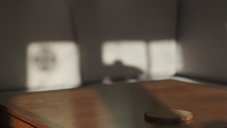 female hand lifting ceramic cup from wooden table and put it back