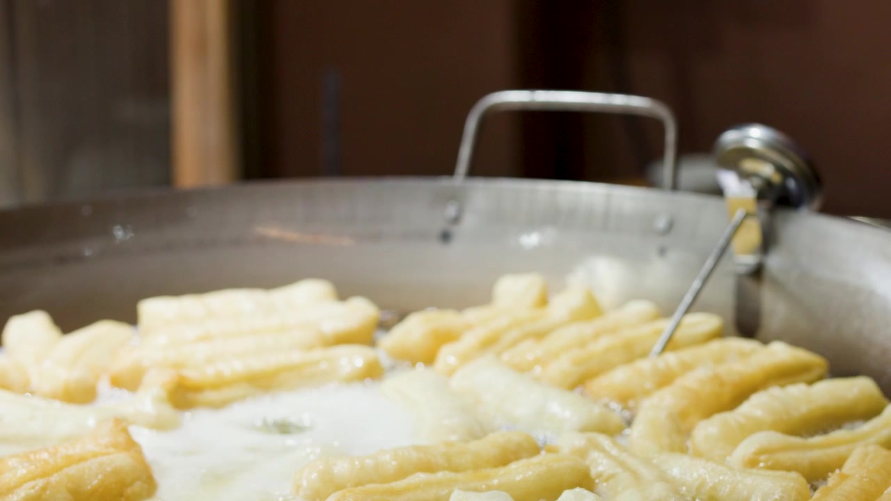 Deep Frying Youtiao Dough Sticks in a Large Wok