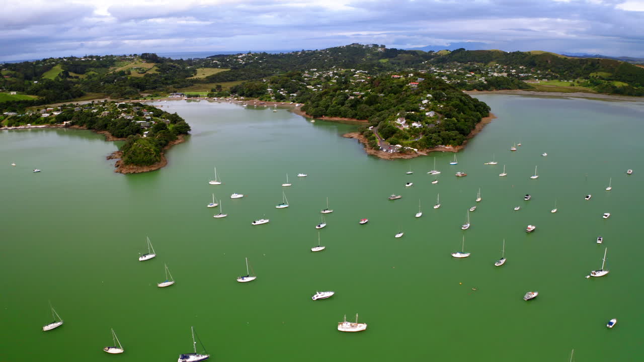 Aerial View of a Coastal Bay with Sailboats and Residential Areas