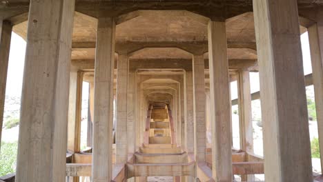 upward pan view of abandoned and disused bridges near hampi, india