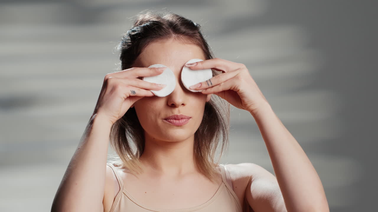 Woman using cotton pads for skincare