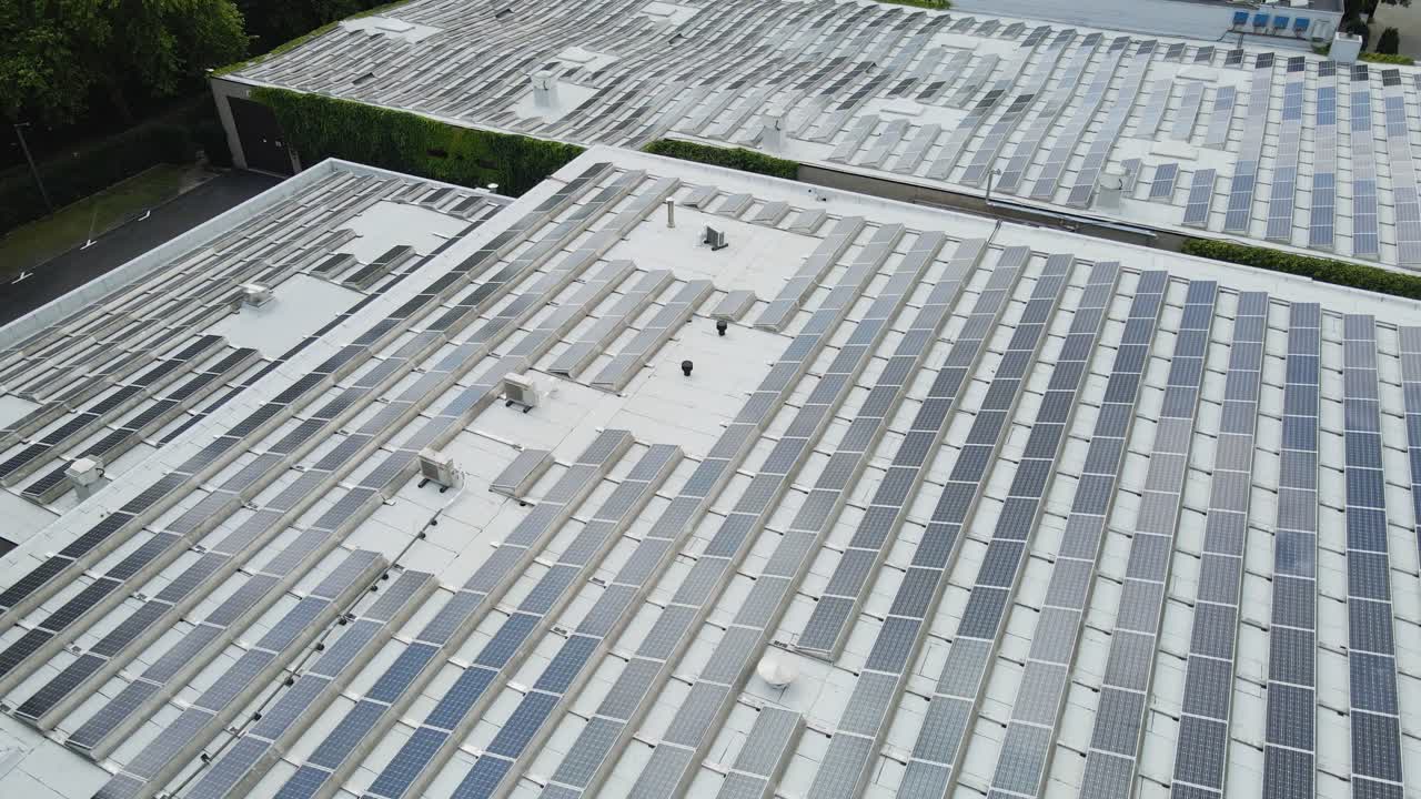 Beautiful aerial of a office rooftops filled with photovoltaic solar panels on a sunny day
