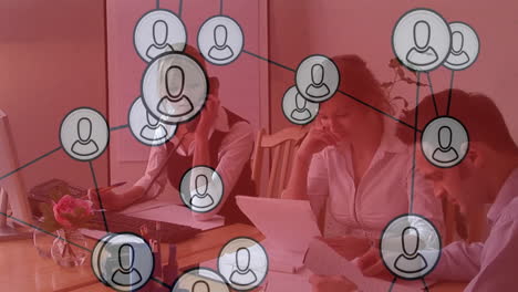 network of user icons animation over business people working at table