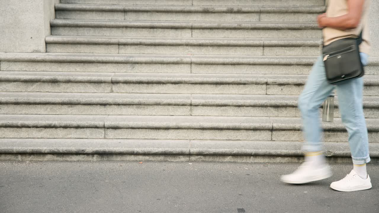 Runner is sprinting into frame across path by stone staircase, and people are walking toward steps