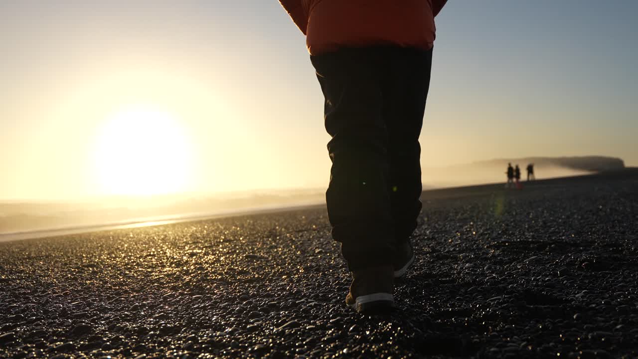 People on a beach at sunset