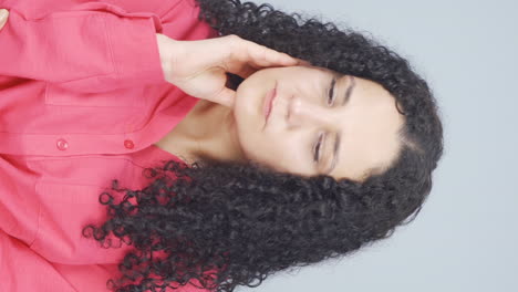 Vertical-video-of-Thoughtful-young-woman-towards-the-camera.