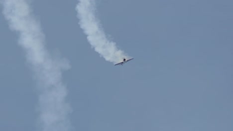 stunt plane in a stalled spiral with smoke trail