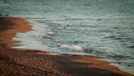 Waves-crashing-on-sandy-beach-at-golden-hour