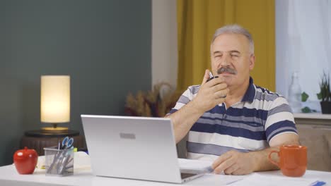 home office worker sprays perfume on old man.