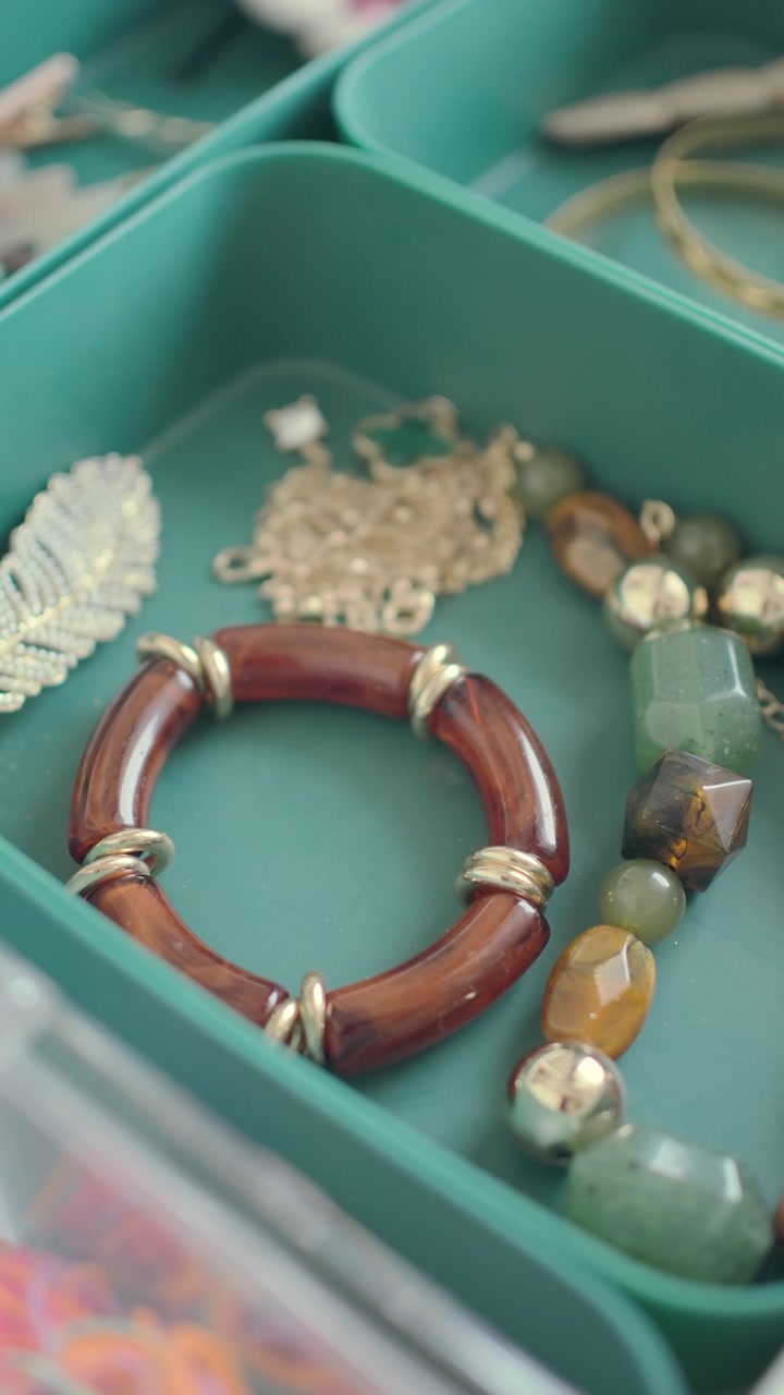 Close-up of Stylish Jewelry and Accessories in a Teal Organizer