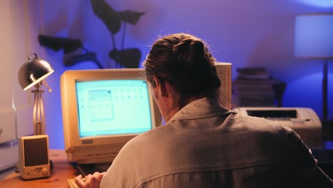 man working and gaming on retro computer pc, it engineer with vintage computer at home, using old fashion technology, close up of retro setup.