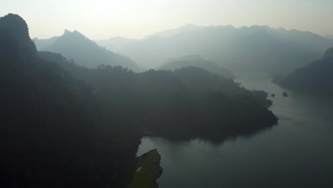 Mist-drifts-across-the-surface-of-the-emerald-green-waters-of-Ba-Be-Lake