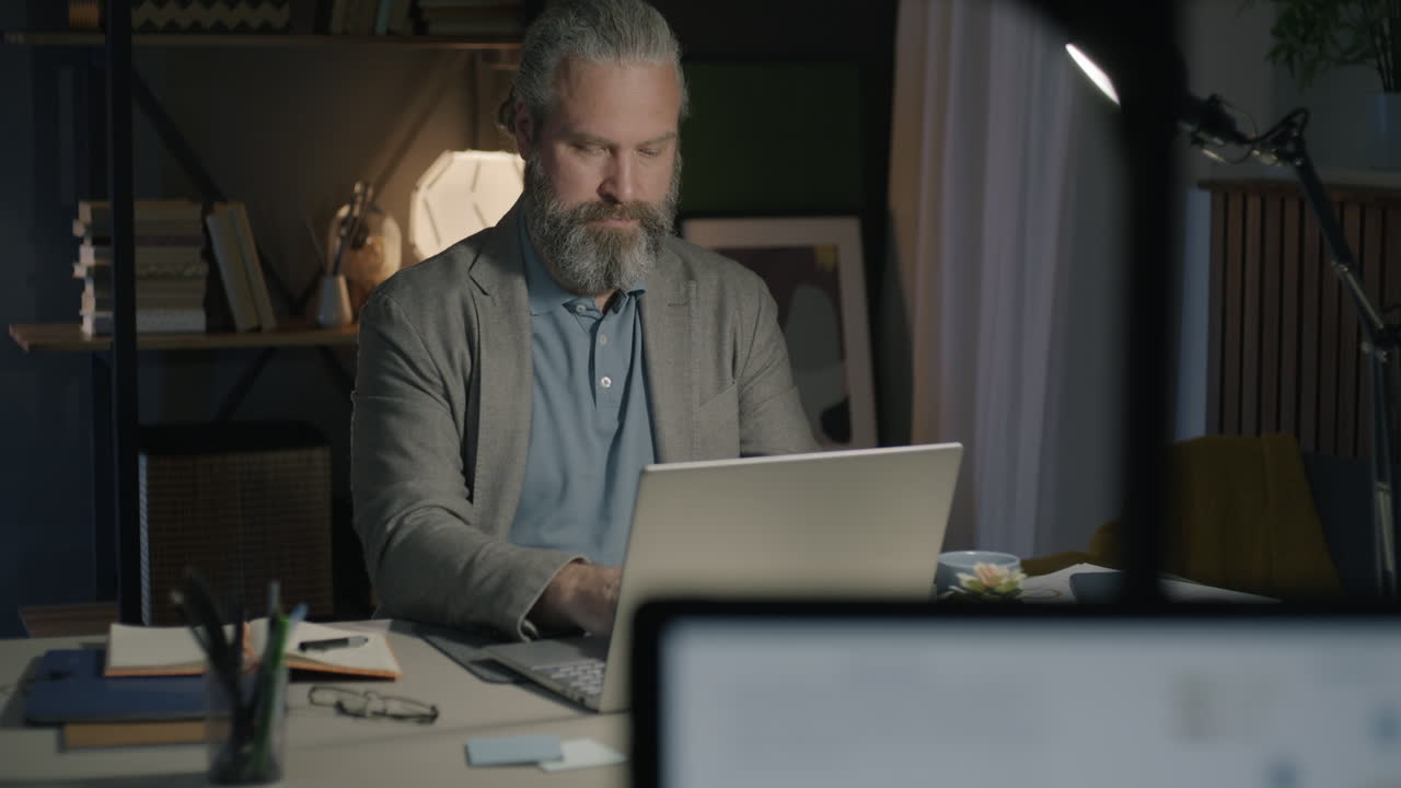 Man Working Late at Home Office