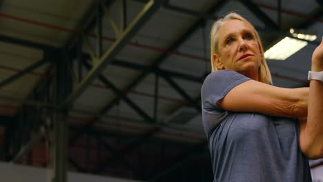 senior woman stretching in fitness studio 4k