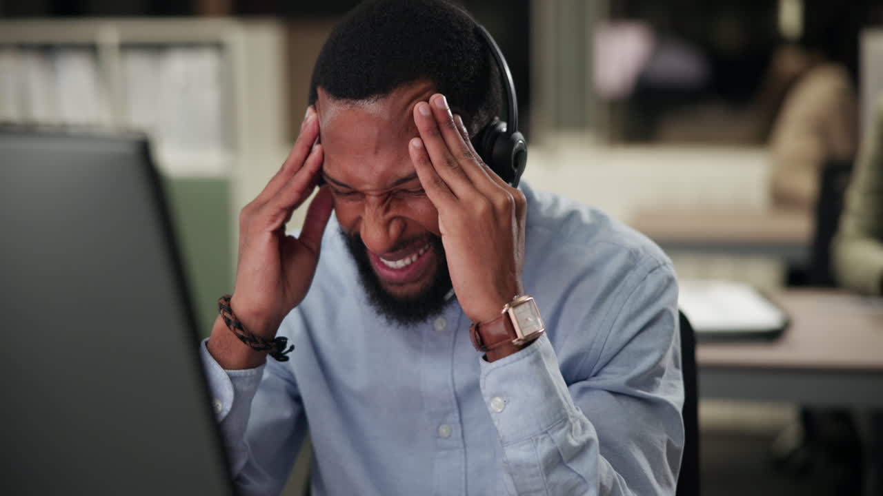 Man experiencing headache and stress at work