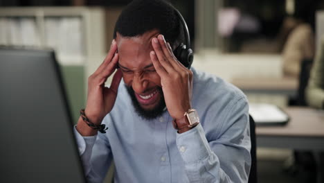 man experiencing headache and stress at work