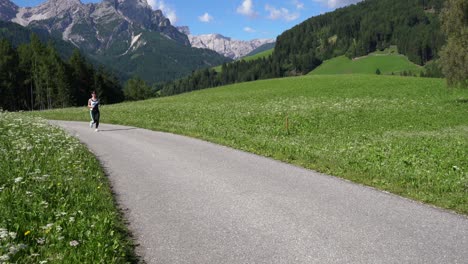 woman jogging outdoors. italy dolomites alps