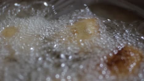 close up stir and turn fried shrimp patty in hot frying pan