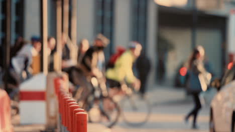 anonymous crowd of people walking cycling bicycles commuters london city street slow motion