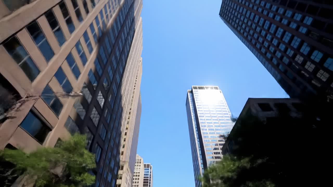 Aerial Perspective of Urban Skyscrapers Under a Clear Blue Sky, Capturing the Majestic Architecture and Modern Design of City Buildings in Full View